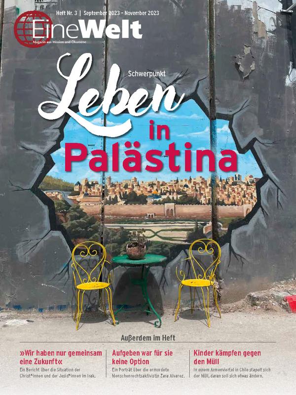 Cover EineWelt 3/23 zeigt ein Graffiti an der Mauer in der Nähe von Bethlehem. Das Graffiti suggeriert ein Loch in der Mauer, durch welches man die Häsuewr auf der anderen Seite sieht.© Foto: Corinna Waltz/EMW
